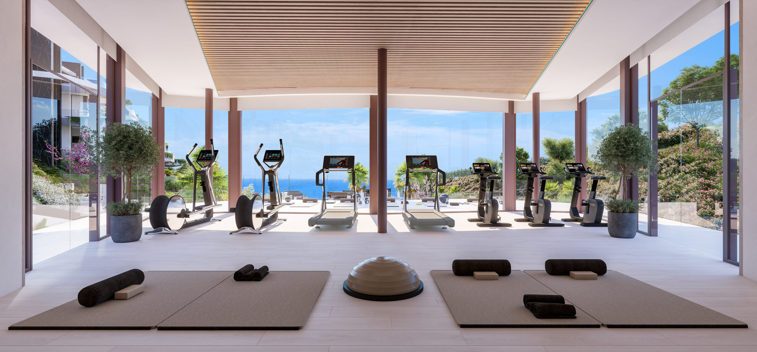 Fitnessruimte met open zicht op zee en bergen